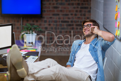 Smiling man talking on phone in office