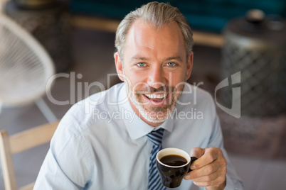 Portrait of smiling man having cup of coffee