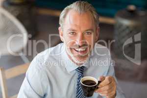 Portrait of smiling man having cup of coffee