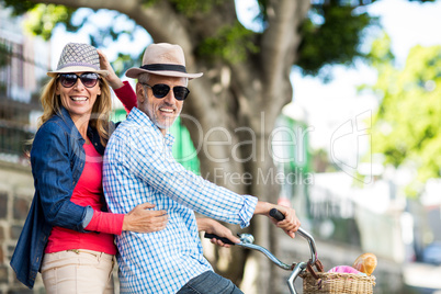 Portrait of mature couple riding bicycle