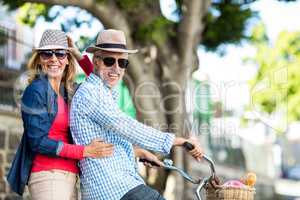 Portrait of mature couple riding bicycle