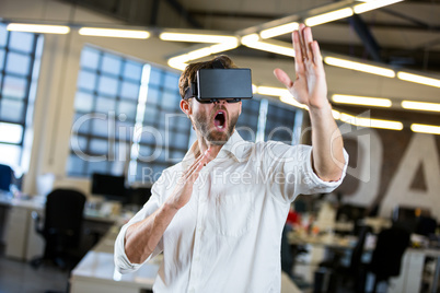 Young businessman using virtual reality simulator