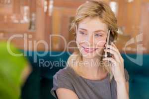 Smiling woman talking on mobile phone