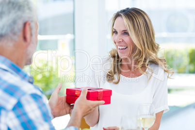 Man giving gift box to wife