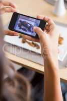 Woman taking photograph of meal