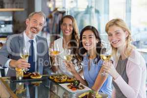 Portrait of happy business colleagues holding beer glasses while