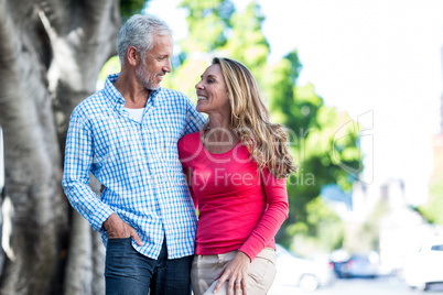 Romantic mature couple standing against tree