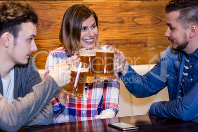 Friends toasting beer at restaurant