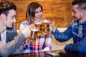 Friends toasting beer at restaurant