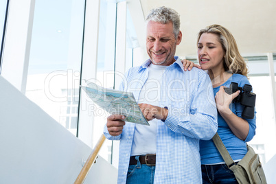 Front view of mature couple reading map