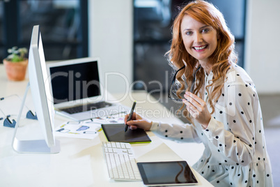 Businesswoman using graphics tablet