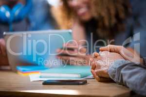 Businesswoman with hands clasped in office