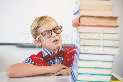 Shocked schoolkid pretending to be a teacher in classroom