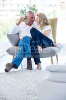 Romantic mature couple with red wine at home