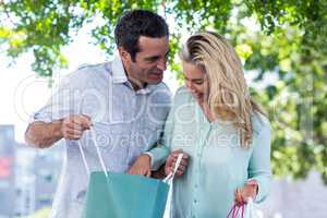 Happy couple looking in shopping bags