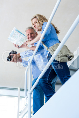 Low angle view of mature couple reading map