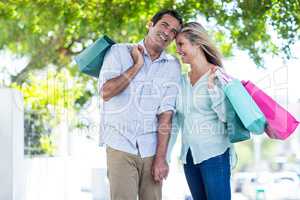 Cheerful couple with shopping bags