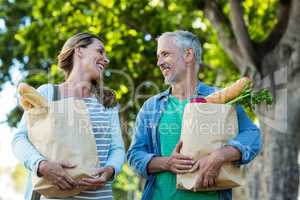 Happy couple holding shopping bags