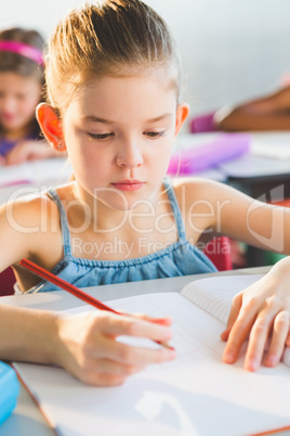 Close-up of schoolkid doing homework in classroom