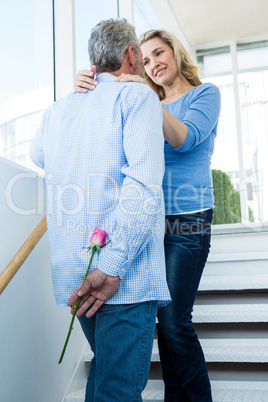 Man hiding rose from woman Man hiding rose from woman