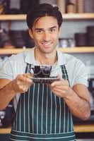 Waiter offering a cup of coffee