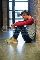 Stressed man sitting in building