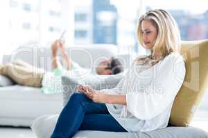 Young woman sitting on couch at home