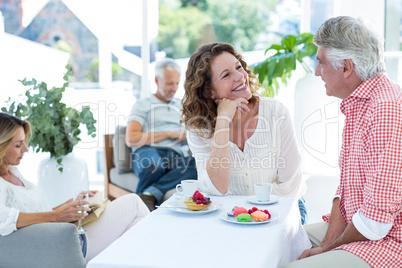 Couple smiling while talking in restaurant