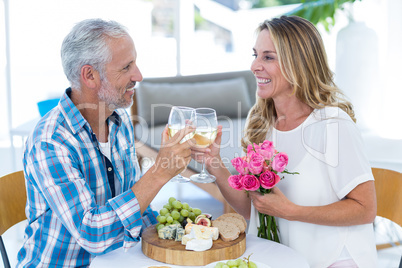 Mature couple toasting wineglass in restaurant