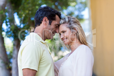 Romantic couple standing by building