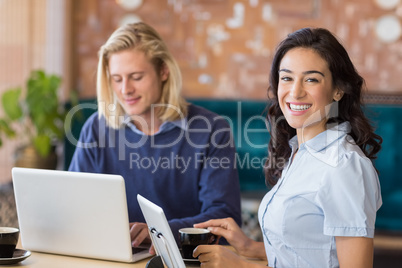 Business colleagues using laptop and digital tablet