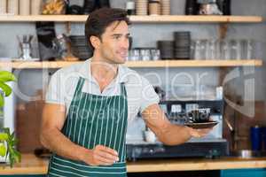 Waiter offering a cup of coffee