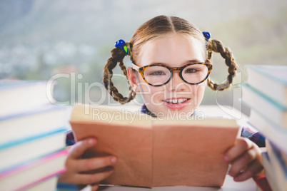 Close-up of schoolkid reading book in classroom