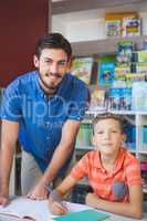 Teacher and school kid smiling in library