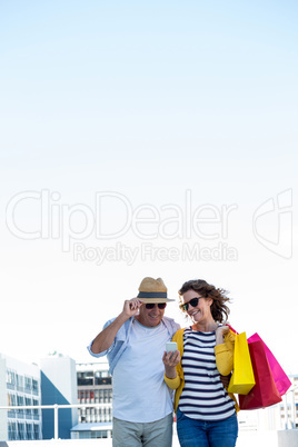 Happy couple using mobile phone
