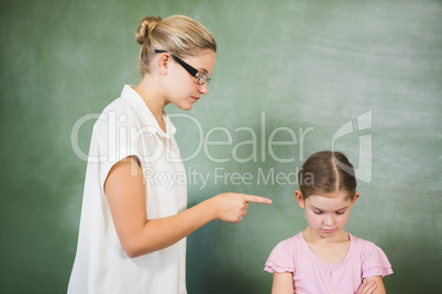 Female teacher shouting at girl in classroom