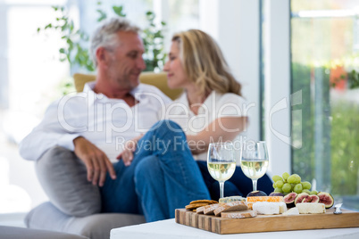 White wine and food on table with romantic couple