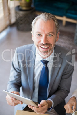 Businessman using digital tablet in cafÃ©