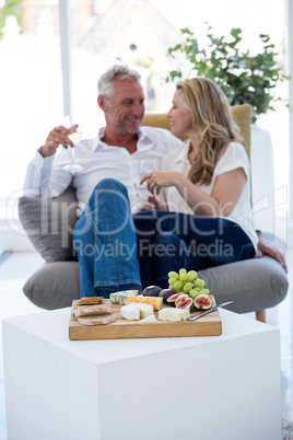 Food on table with smiling couple