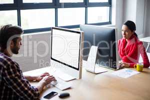 Colleagues working on computer in office