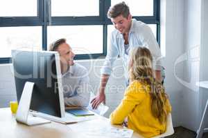 Business people smiling while discussing in office