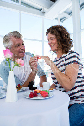 Happy man gifting ring to woman
