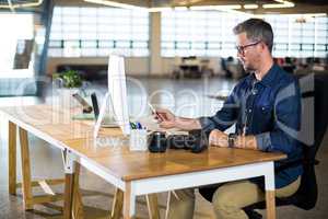 Man using mobile phone in office