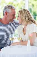 Romantic smiling mature couple with white wine