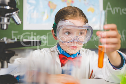 Schoolgirl doing a chemical experiment in laboratory