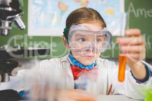 Schoolgirl doing a chemical experiment in laboratory