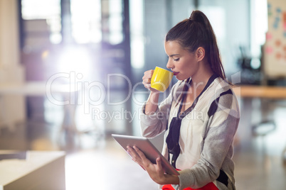 Woman drinking coffee in office