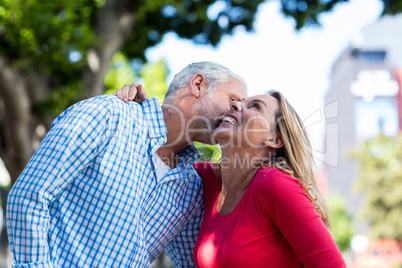 Romantic mature man kissing woman