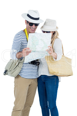 Couple reading map against white background