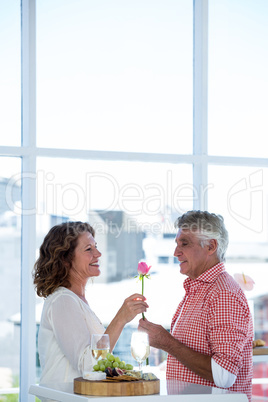 Man giving flower to happy woman